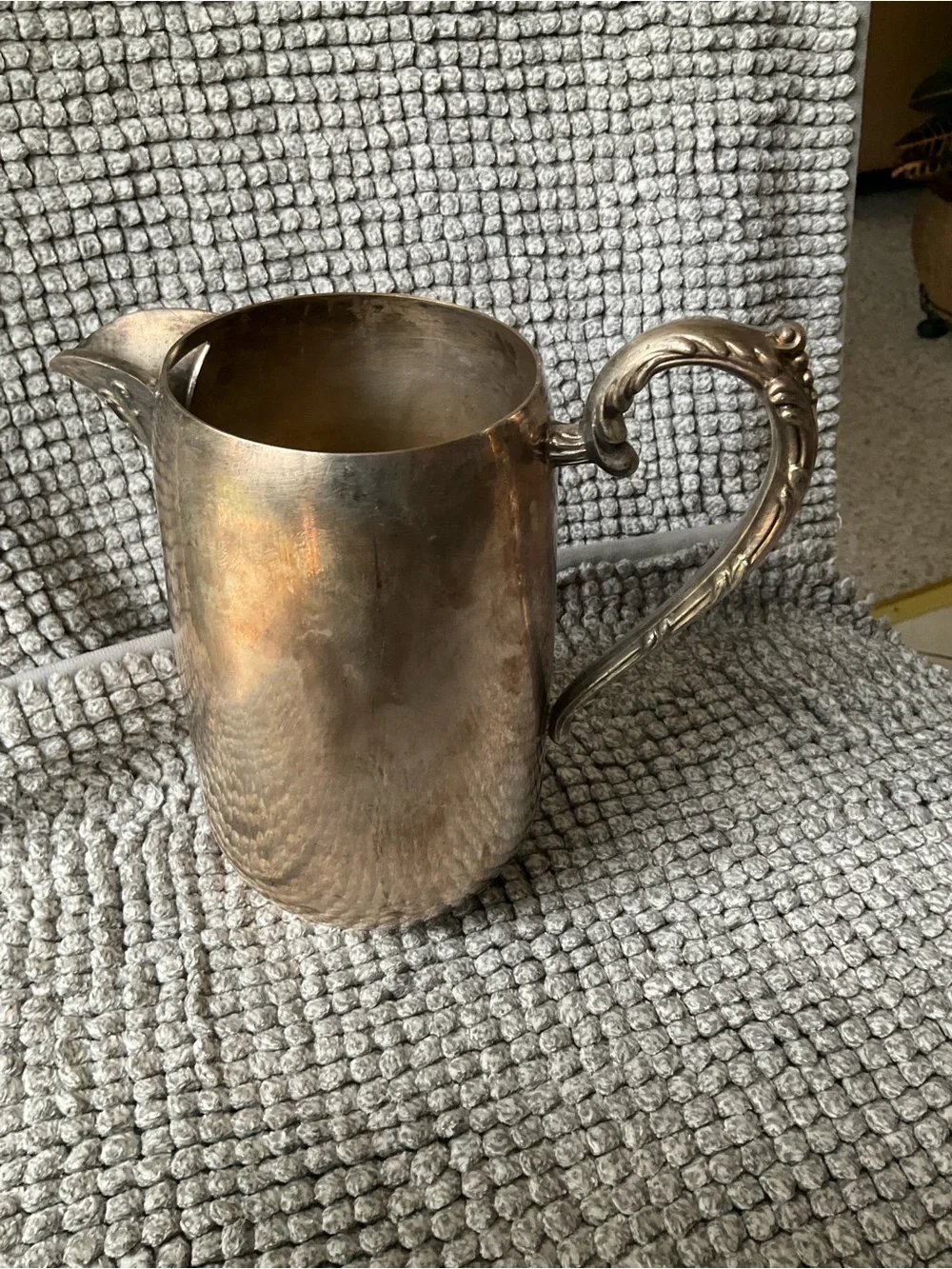 Polished Silver-Tone Decorative Metal Pitcher with Ornate Handle